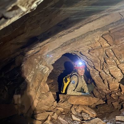 Ranger Erin Pitts with Virginia State Parks inside Lone Ash Cave at New River Trail State Parks on a ranger-led wild caving tour.