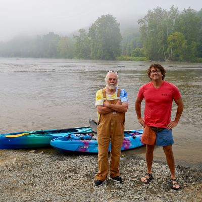 Episode guests Kevin Combs and Ricky Barton stand in front of kayaks on the banks of the New River in Fries, VA on a foggy summer morning.