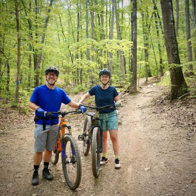 Morgan and Charles mountain biking together on the Western Slope of Massanutten Resort in the Shenandoah Valley, Virginia