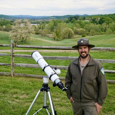 Ranger Patrick Mcnamara of Virginia State Parks with a telescope at Sky Meadows State Park during a park astronomy program.
